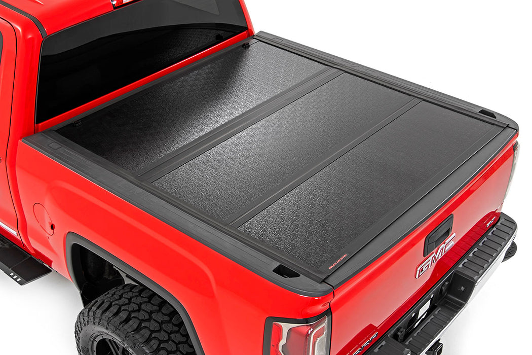 Rough Country 47119551 Low Profile Hard Tri-Fold Tonneau Cover 14-18 1500, 15-19 2500/3500 HD 5.5 Foot Bed w/Rail Caps Rough Country - Truck Part Superstore