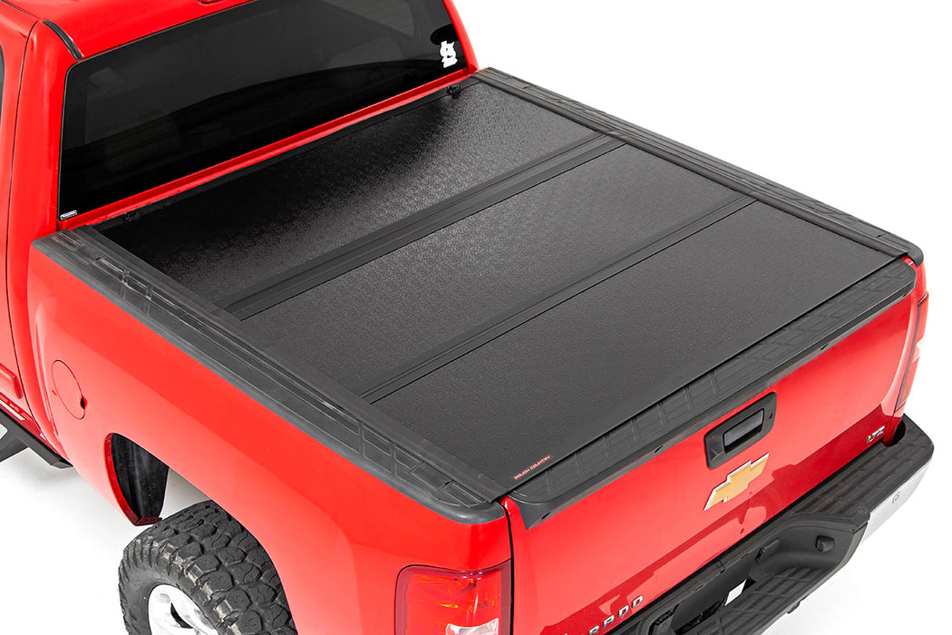 Rough Country 47113551 Low Profile Hard Tri-Fold Tonneau Cover 07-13 1500 5.5 Foot Bed w/Rail Caps Rough Country - Truck Part Superstore