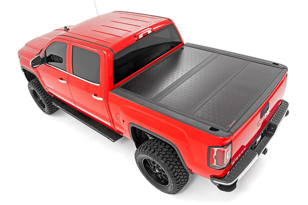 Rough Country 47119551 Low Profile Hard Tri-Fold Tonneau Cover 14-18 1500, 15-19 2500/3500 HD 5.5 Foot Bed w/Rail Caps Rough Country - Truck Part Superstore